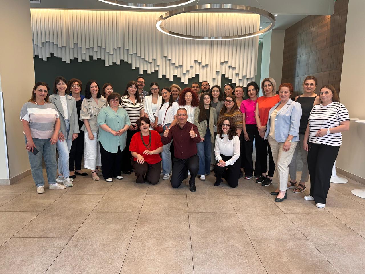  Groupshot, Person, People, Adult, Female, Woman, Male, Man, Clothing, Jeans, Pants, Footwear, Shoe, Face, Head, Formal Wear, Suit, Ian Eagle, Anna Dogonadze, Muhammed Bozdağ, Vian Dakhil, Nalini Malani, Marat Bisengaliev, Alma Prica, Aida El-Kashef, Paulina Aguirre, Pauline Croze, Heather Maloney, Negar Khan, D'Arcy Carden, Sergio Villarreal Barragán