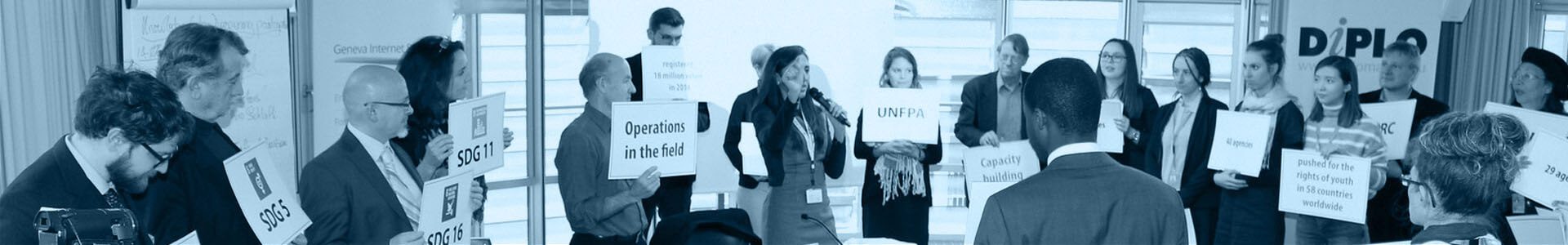 aboutusbanner2 People, Person, Advertisement, Poster, Adult, Male, Man, Clothing, Formal Wear, Suit, Face, Head, Indoors