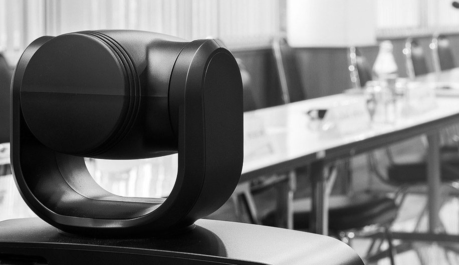 camera-video-conferencing-meeting-bw-916x530px Cushion, Home Decor, Dining Table, Furniture, Table, Indoors, Lighting, Electronics, Speaker