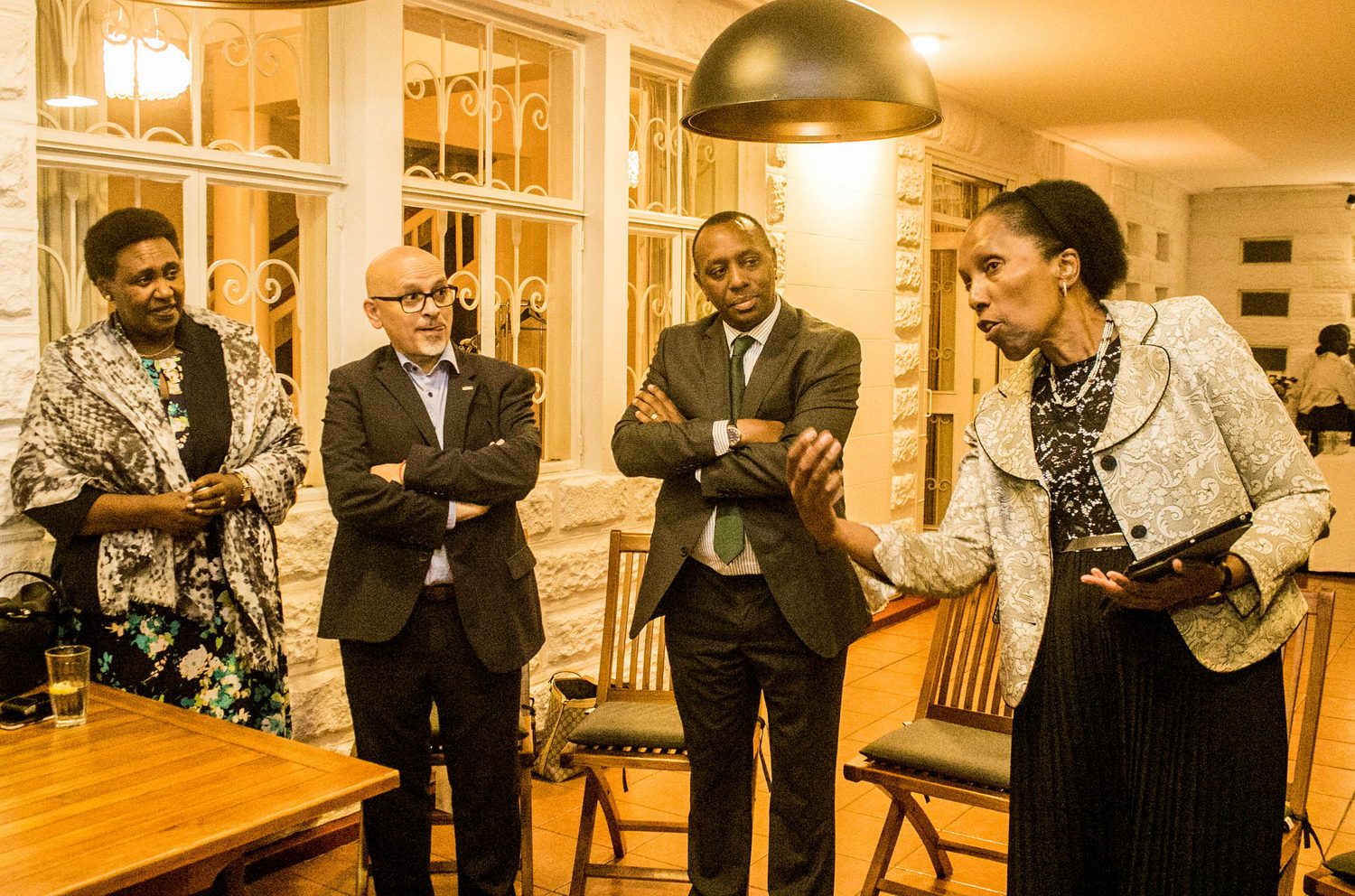  Blazer, Clothing, Coat, Jacket, Adult, Male, Man, Person, Dining Table, Furniture, Table, Plywood, Wood, Formal Wear, Face, Head, Suit, Lighting