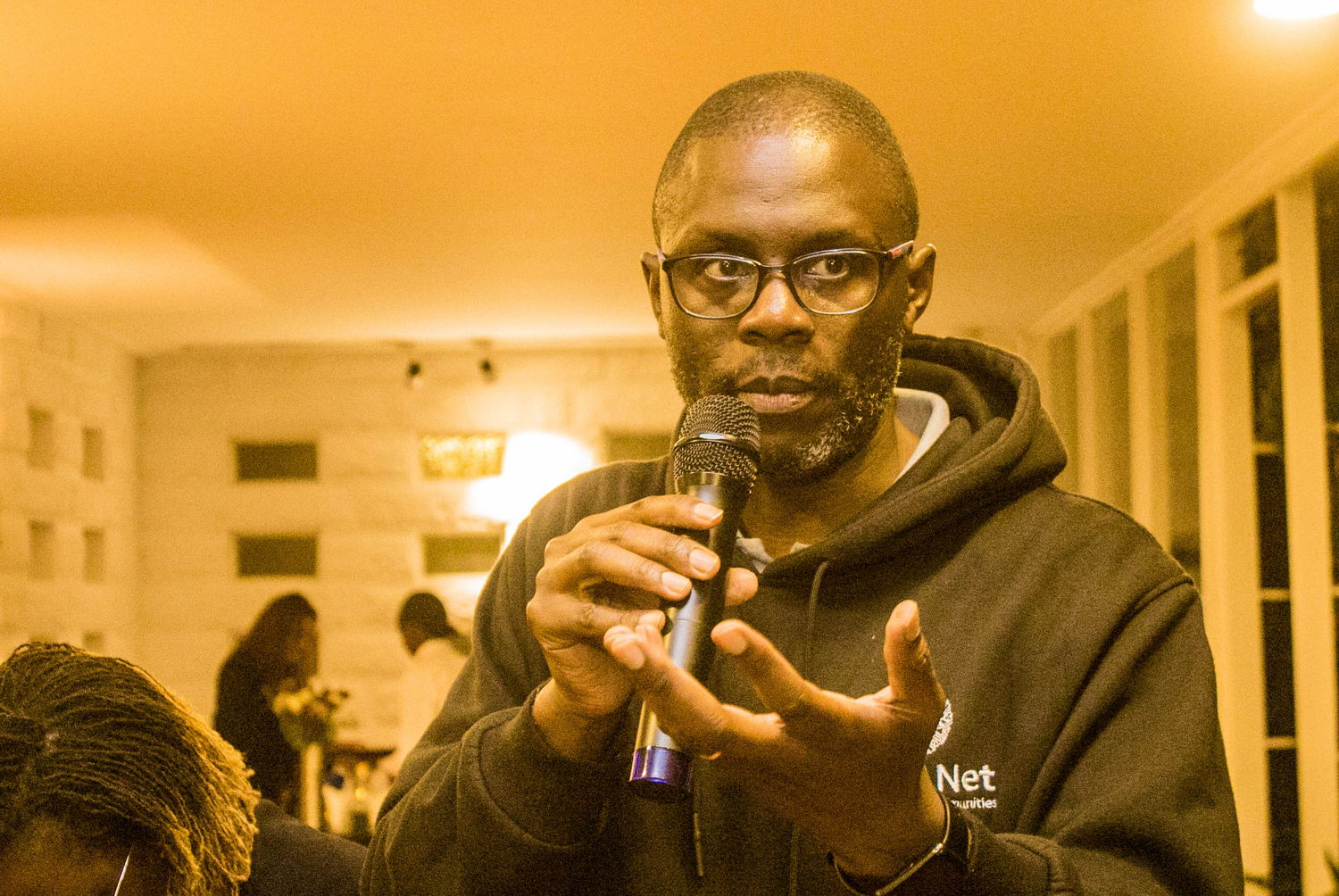  Electrical Device, Microphone, Body Part, Finger, Hand, Person, Adult, Male, Man, Crowd, People, Accessories, Glasses, Face, Head, Photography, Portrait, Performer, Solo Performance, Audience