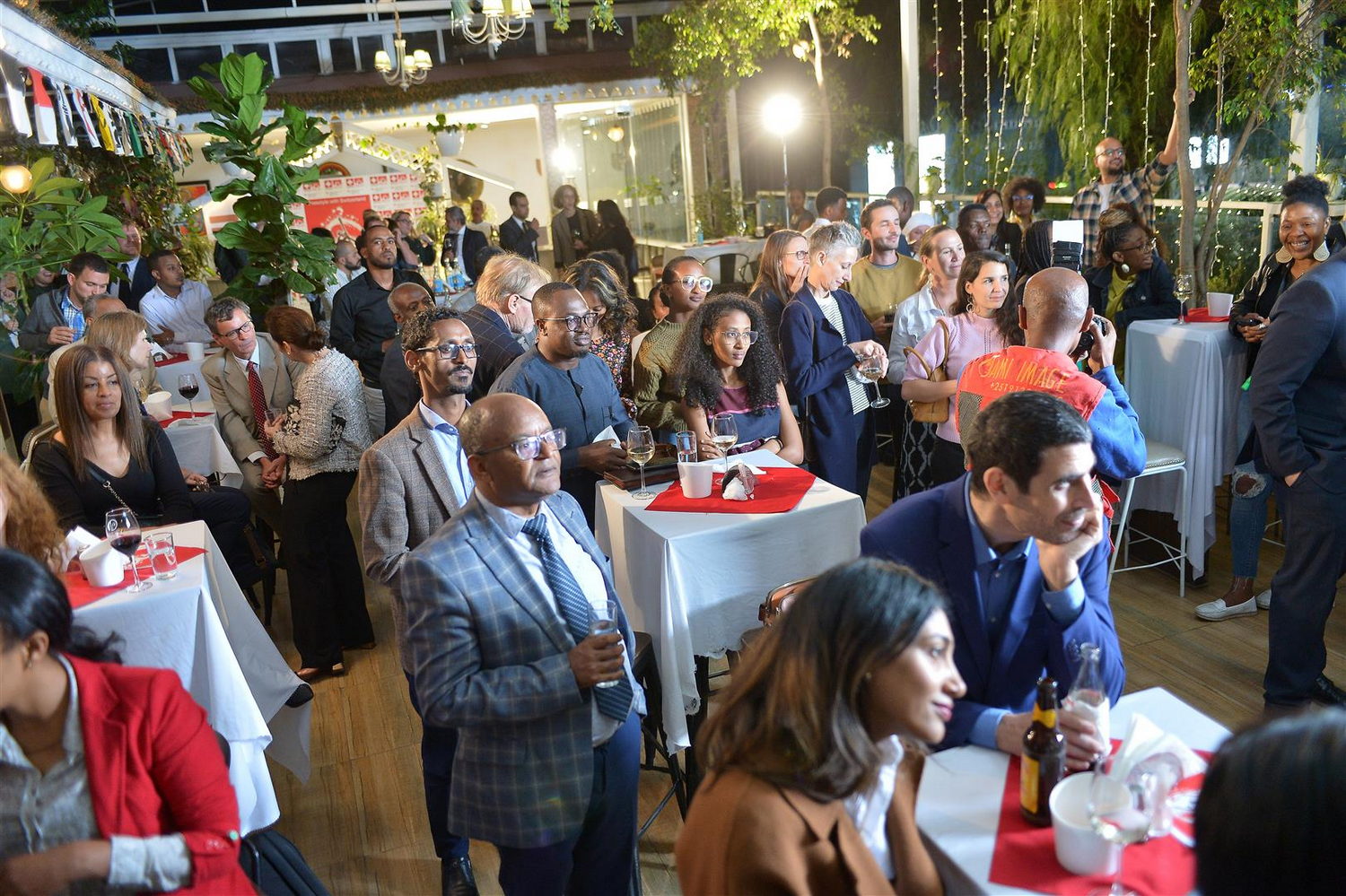  People, Person, Adult, Female, Woman, Indoors, Restaurant, Male, Man, Face, Head, Fun, Party, Clothing, Footwear, Shoe, Food, Food Court, Formal Wear, Suit, Alcohol, Beer, Beverage