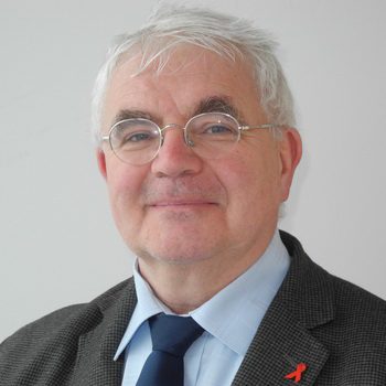 Face, Head, Person, Photography, Portrait, Accessories, Formal Wear, Tie, Adult, Male, Man, Clothing, Suit, Blonde, Hair, Glasses, Coat, People